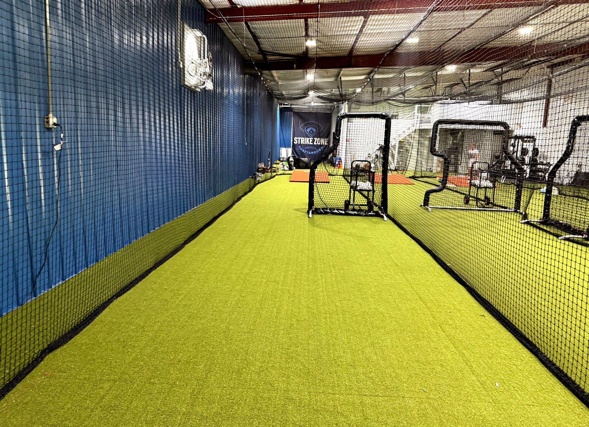 Strike Zone Chattanooga batting facility interior with Strike Zone banner